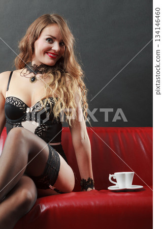 Woman wearing sexy lingerie having coffee cup Woman wearing sexy lingerie having coffee cup 134146460