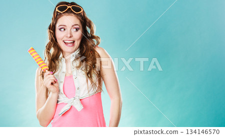 Summer woman eating popsicle ice pop cream 134146570