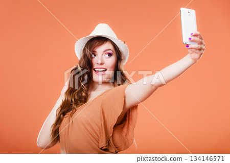 Woman taking self picture with smartphone camera Woman taking self picture with smartphone camera 134146571