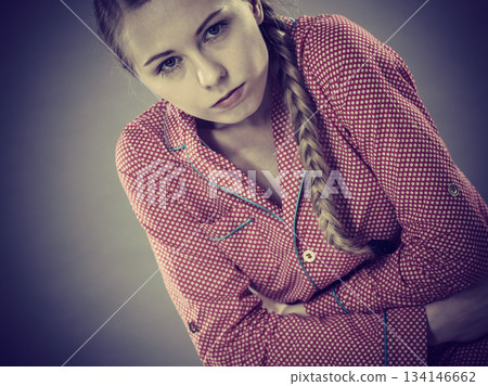 Sad young teenager woman on bed feeling pain Sad young teenager woman on bed feeling pain 134146662