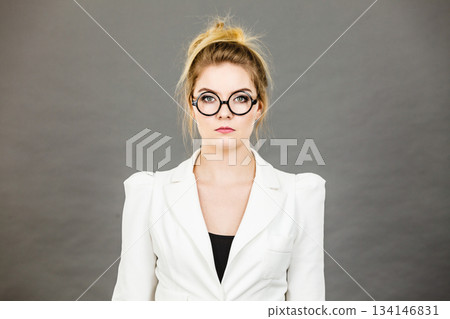 Bored focused college woman teacher wearing eyeglasses Bored focused college woman teacher wearing eyeglasses 134146831