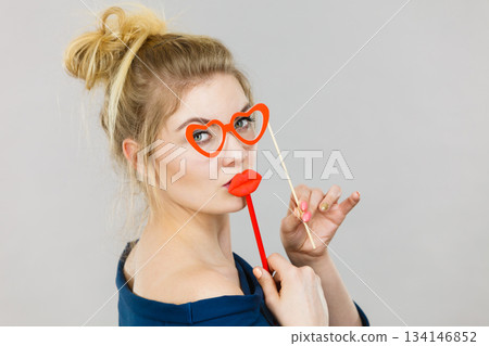 woman holds carnival accessories on stick woman holds carnival accessories on stick 134146852
