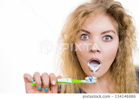 Woman brushing cleaning teeth Woman brushing cleaning teeth 134146866
