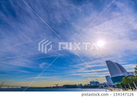 Yokohama cityscape in Japan in December. Views include sunlight, halos, and numerous contrails "running" across the December sky. Ray of hope = Yokohama 134147126