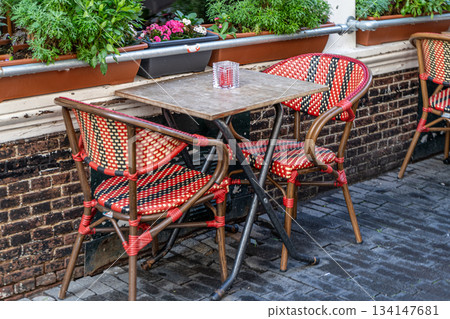 Empty table and chairs at a street cafe in Amsterdam Empty table and chairs at a street cafe in Amsterdam 134147681