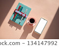 Notebook with colorful markers, cup of espresso and smartphone with mock up screen for app display 134147992