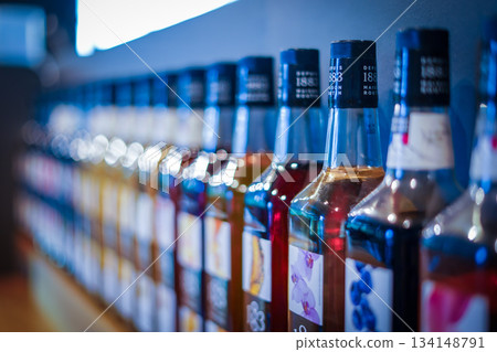 Display shelves lined with bottles Display shelves lined with bottles 134148791