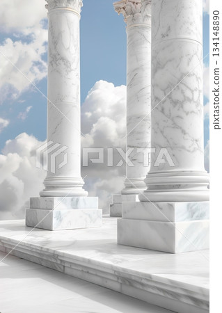 Tall white pillars stand firmly on a marble base. Soft clouds drift in a bright sky above. The space feels open and expansive, drawing attention to the architecture 134148890