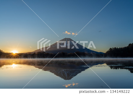 Mount Fuji and the morning sun reflected on the lake surface from the shore of Lake Shoji 134149222