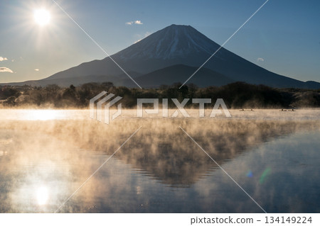 Mount Fuji and the morning sun reflected on the lake surface from the shore of Lake Shoji Mount Fuji and the morning sun reflected on the lake surface from the shore of Lake Shoji 134149224