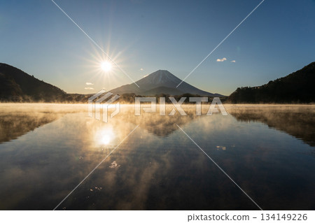 Mount Fuji and the morning sun reflected on the lake surface from the shore of Lake Shoji 134149226