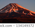 Mount Fuji and the Hoei crater blazing in the morning glow from the Torigoki Plateau Observatory on Mount Echizen in the Ashitaka Mountains 134149372