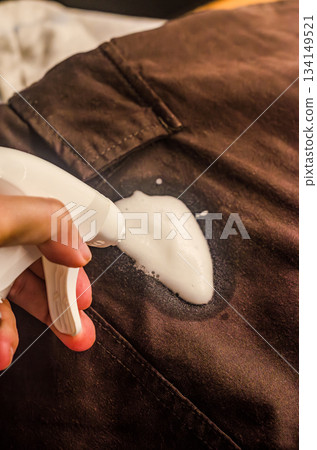 Applying Foam Cleaner to Fabric Stain Close-Up Applying Foam Cleaner to Fabric Stain Close-Up 134149521