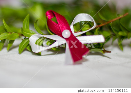 Wedding favors resting on table near myrtle sprig Wedding favors resting on table near myrtle sprig 134150111