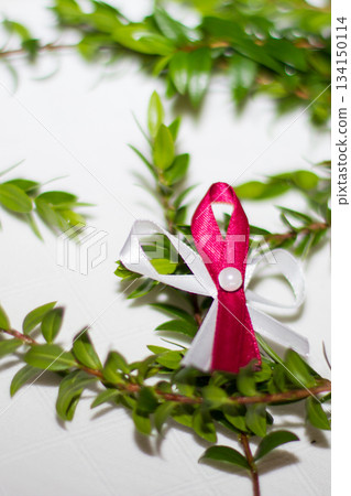 Myrtle sprig adorned with red and white wedding favor ribbon 134150114