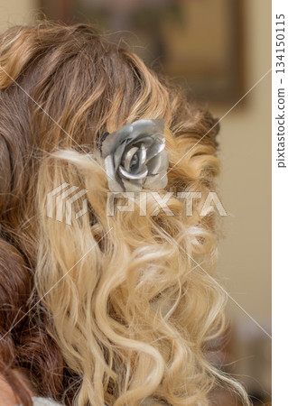 Blonde bride showing silver rose hair clip on wavy hair 134150115