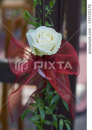 White rose with red ribbon decorating wedding ceremony White rose with red ribbon decorating wedding ceremony 134150176