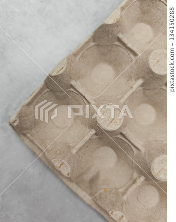 Empty egg carton on gray background for easter or pancake day Empty egg carton on gray background for easter or pancake day 134150288