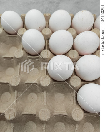 White eggs resting in cardboard container for easter breakfast White eggs resting in cardboard container for easter breakfast 134150291