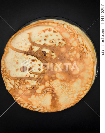 Delicious homemade crepes or pancakes resting on a dark background for maslenitsa breakfast or shrove tuesday 134150297