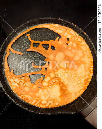Bunny shaped pancake cooking in frying pan for maslenitsa or shrove tuesday breakfast Bunny shaped pancake cooking in frying pan for maslenitsa or shrove tuesday breakfast 134150298