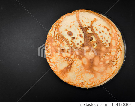 Delicious homemade crepes resting on dark background for breakfast or maslenitsa celebration or shrove tuesday with copy space 134150305