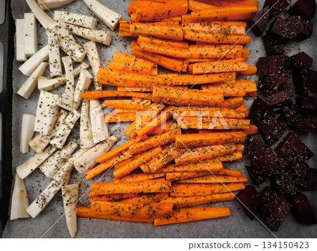 Parsnip, carrot and beetroot batons seasoned and ready for roasting healthy dinner snacks Parsnip, carrot and beetroot batons seasoned and ready for roasting healthy dinner snacks 134150423