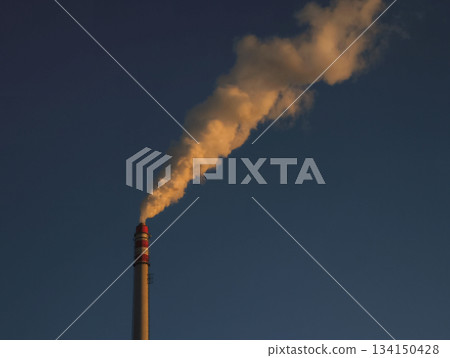 Industrial chimney emitting smoke at sunset in prague 134150428