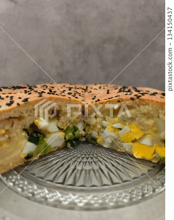 Traditional easter savory pie with eggs and spring onions filling copy space gray background Traditional easter savory pie with eggs and spring onions filling copy space gray background 134150437
