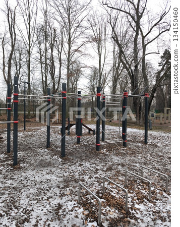 Outdoor gym equipment covered in snow in prague park Stromovka 134150460