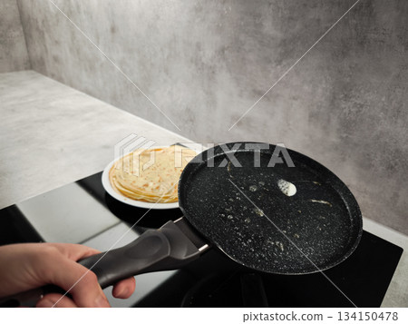 Chef preparing crepes in a frying pan for shrove tuesday, maslenitsa or breakfast Chef preparing crepes in a frying pan for shrove tuesday, maslenitsa or breakfast 134150478