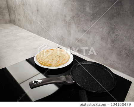 Cooking delicious crepes on a modern induction cooktop in prague for shrove tuesday, maslenitsa or breakfast Cooking delicious crepes on a modern induction cooktop in prague for shrove tuesday, maslenitsa or breakfast 134150479