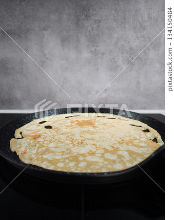 Cooking crepe on frying pan for shrove tuesday, maslenitsa or breakfast celebration Cooking crepe on frying pan for shrove tuesday, maslenitsa or breakfast celebration 134150484