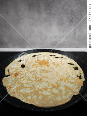 Cooking crepe on frying pan for shrove tuesday, maslenitsa or breakfast celebration Cooking crepe on frying pan for shrove tuesday, maslenitsa or breakfast celebration 134150485