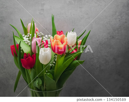 Colorful tulip bouquet symbolizing romantic mood near historic prague landmark, love concept 134150589