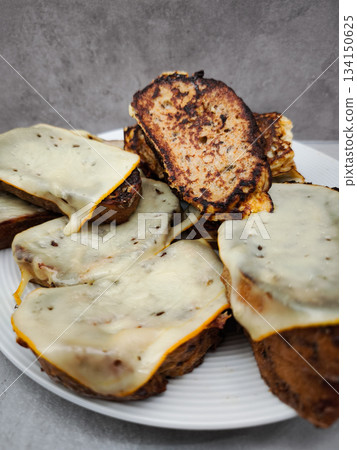 French toast with melted cheese on white plate for breakfast French toast with melted cheese on white plate for breakfast 134150625