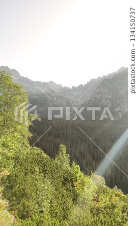 Sunbeam illuminating mengusovska valley in the high tatras mountains 134150737