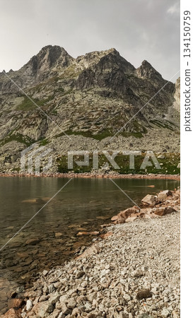 Rysy mountain reflecting in the clear waters of strbske pleso lake in slovakia 134150759