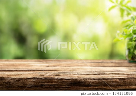 Radiant green spring background panorama with wooden table for a concept Radiant green spring background panorama with wooden table for a concept 134151096