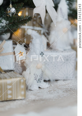 White troll figures under Christmas tree with white decoration. White, silver and gold gift boxes. New Year, Christmas background. Christmas tree,gift White troll figures under Christmas tree with white decoration. White, silver and gold gift boxes. New Year, Christmas background. Christmas tree,gift 134151243