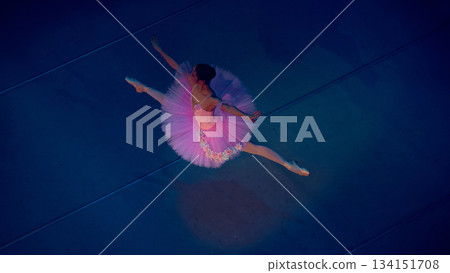 Ballerina in pink tutu executing aerial split. Ballerina in pink tutu executing aerial split. 134151708