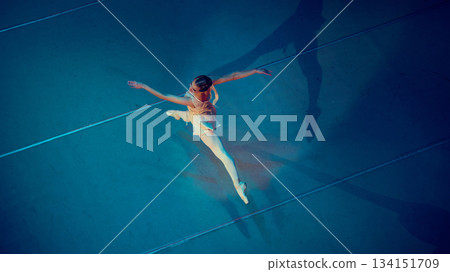 Ballerina captured mid-jump in elongated split. 134151709