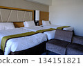 A beautiful hotel room with a triple bed 134151821
