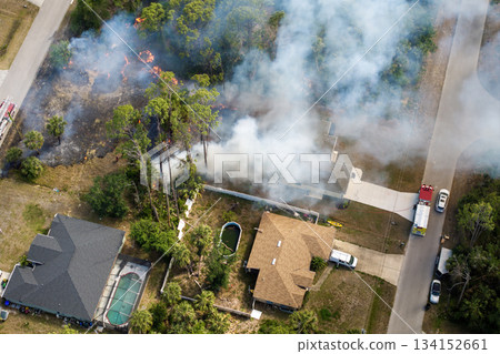 Wildfire rages near homes in Florida town while fire trucks and emergency crew combat the advancing flames Wildfire rages near homes in Florida town while fire trucks and emergency crew combat the advancing flames 134152661