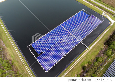 View from above of floating photovoltaic power plant with many rows of solar panels for producing clean electrical energy. Concept of renewable electricity on water surface with no air pollution 134152809