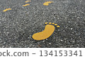Yellow footprints painted on the road 134153341