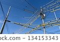 Blue sky and complex intersecting power lines and poles 134153343