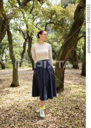 Woman enjoying nature while wearing casual fashionable outfit Woman enjoying nature while wearing casual fashionable outfit 134153351