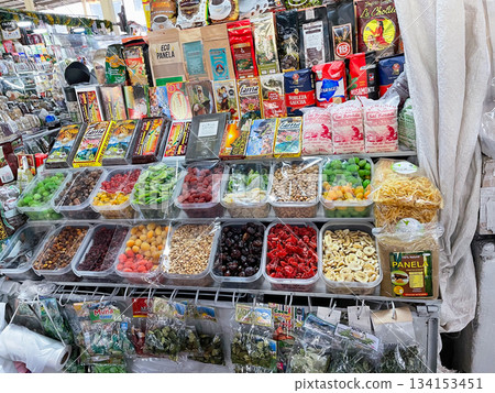 A variety of snacks are displayed on a table, including nuts, dried fruit 134153451