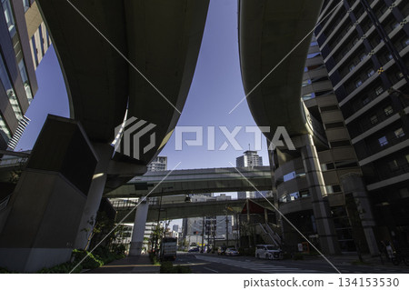 Modern buildings seen from under an urban highway overpass Modern buildings seen from under an urban highway overpass 134153530